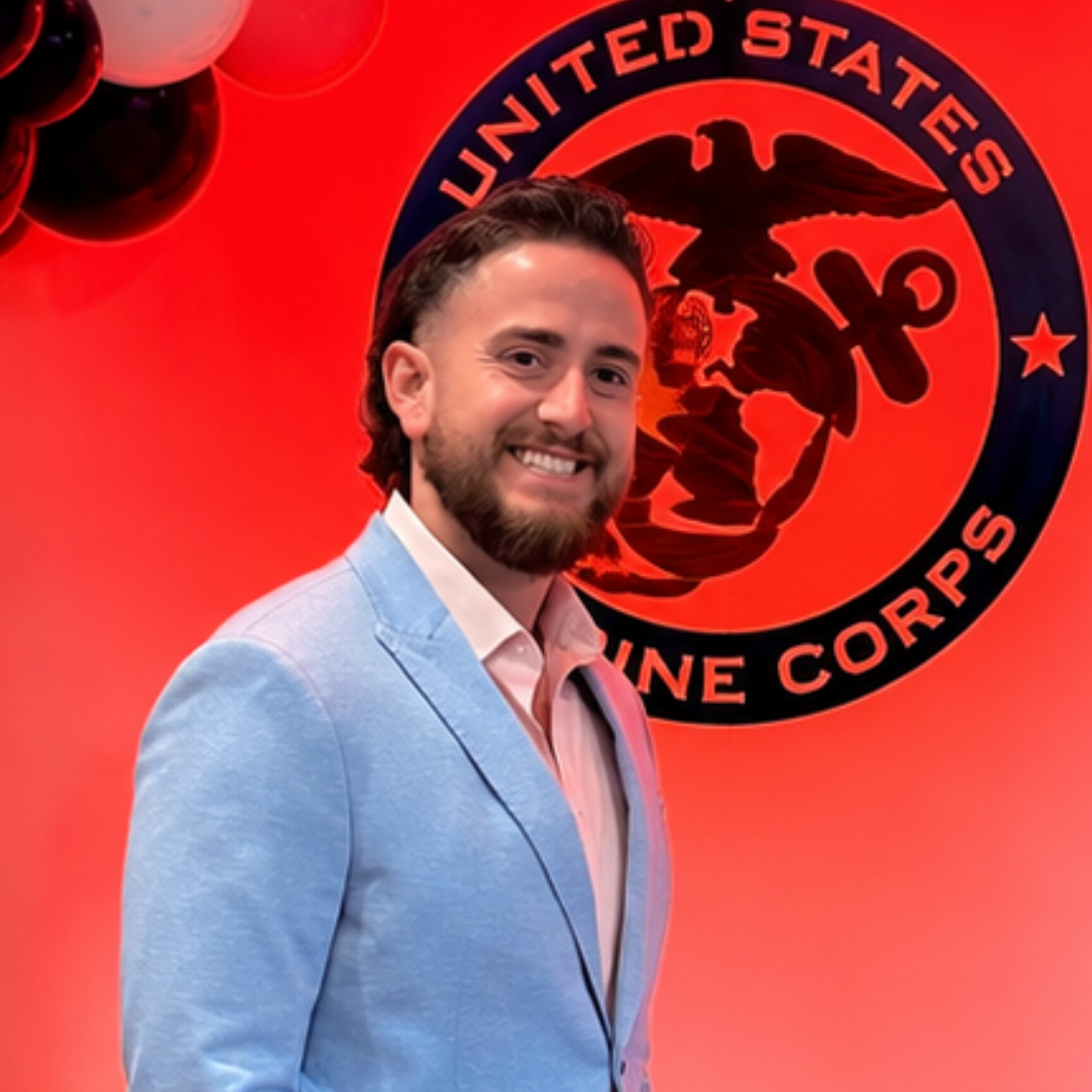 Young man in front of the USMC logo